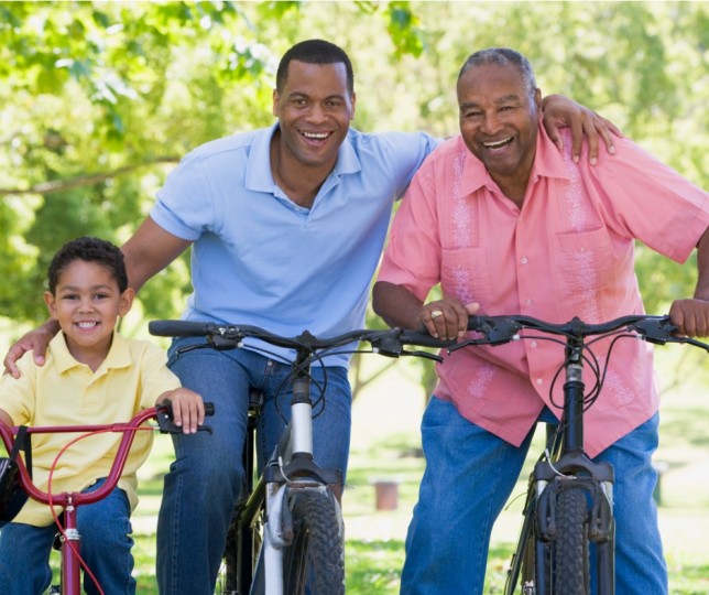 Three generations of men on bikes