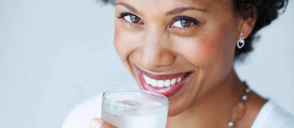 Black woman drinking a glass of water